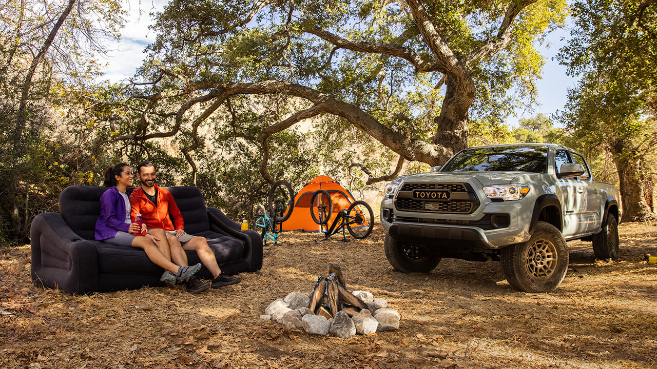 Couple camping with their 2022 Toyota Tacoma