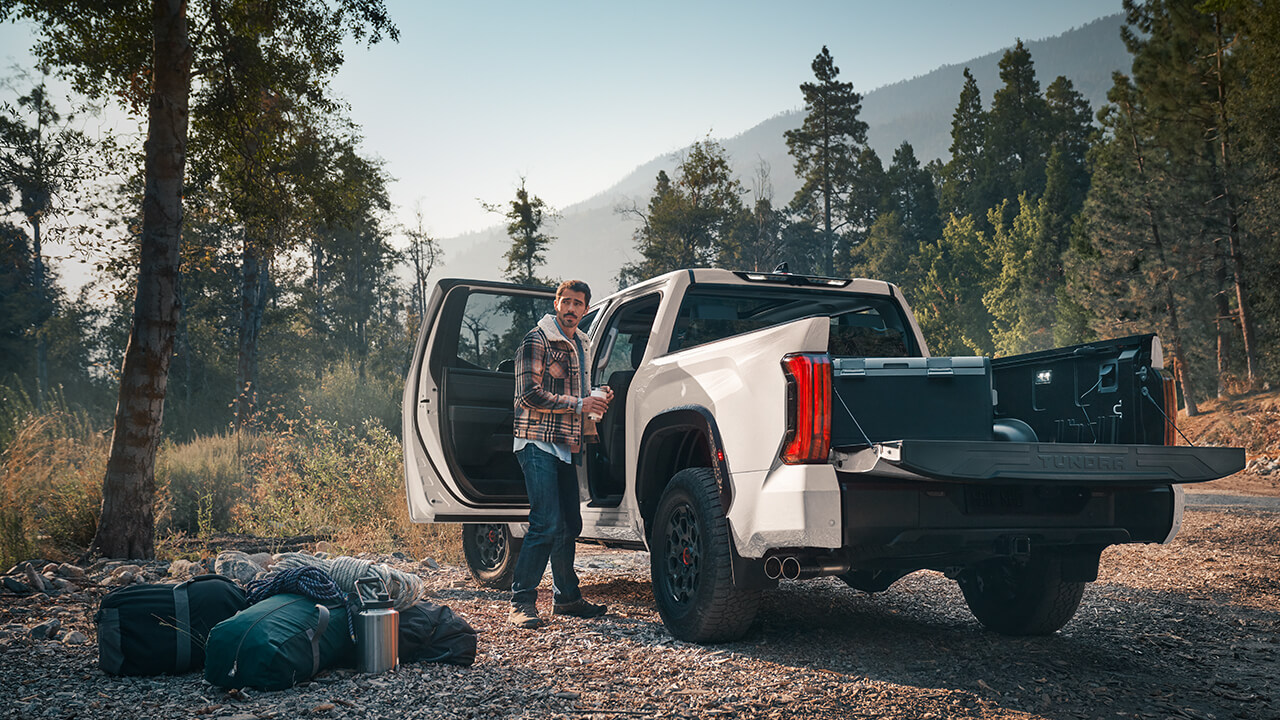Man camping with his white 2022 Toyota Tundra