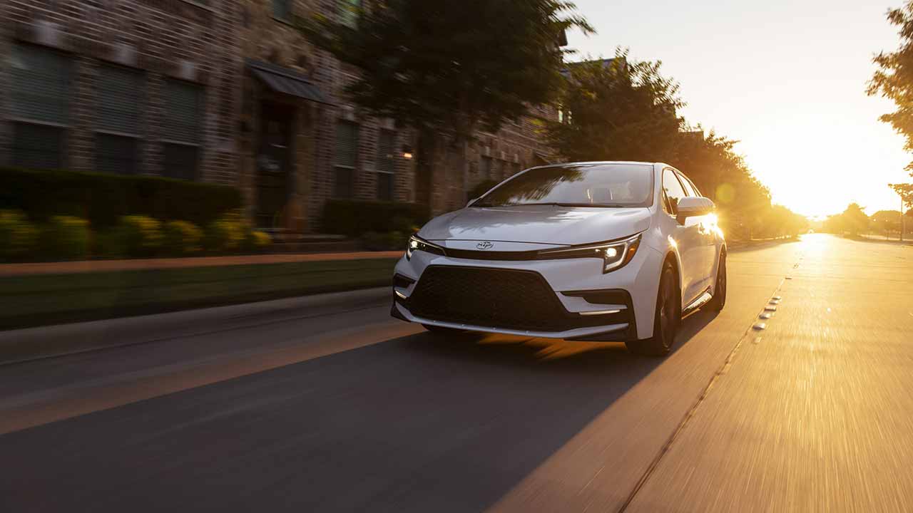 2023 Toyota Corolla driving away from sunset