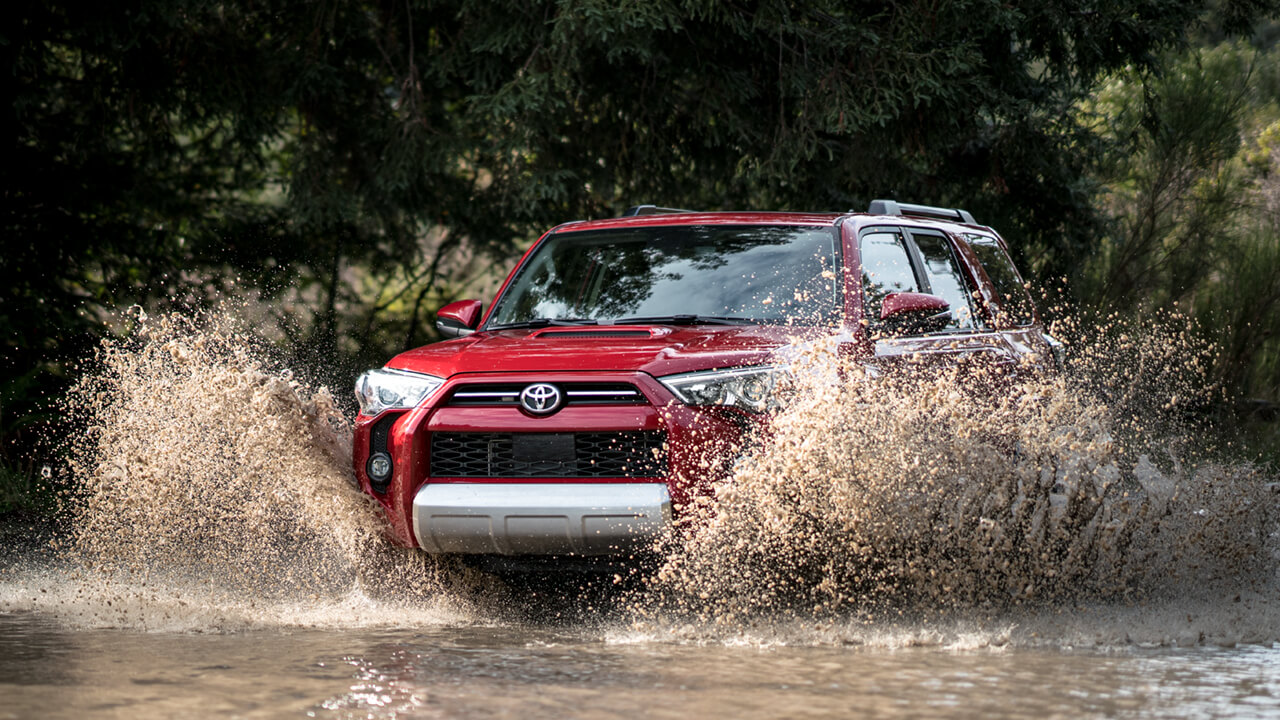 Toyota 4Runner offroading through creek