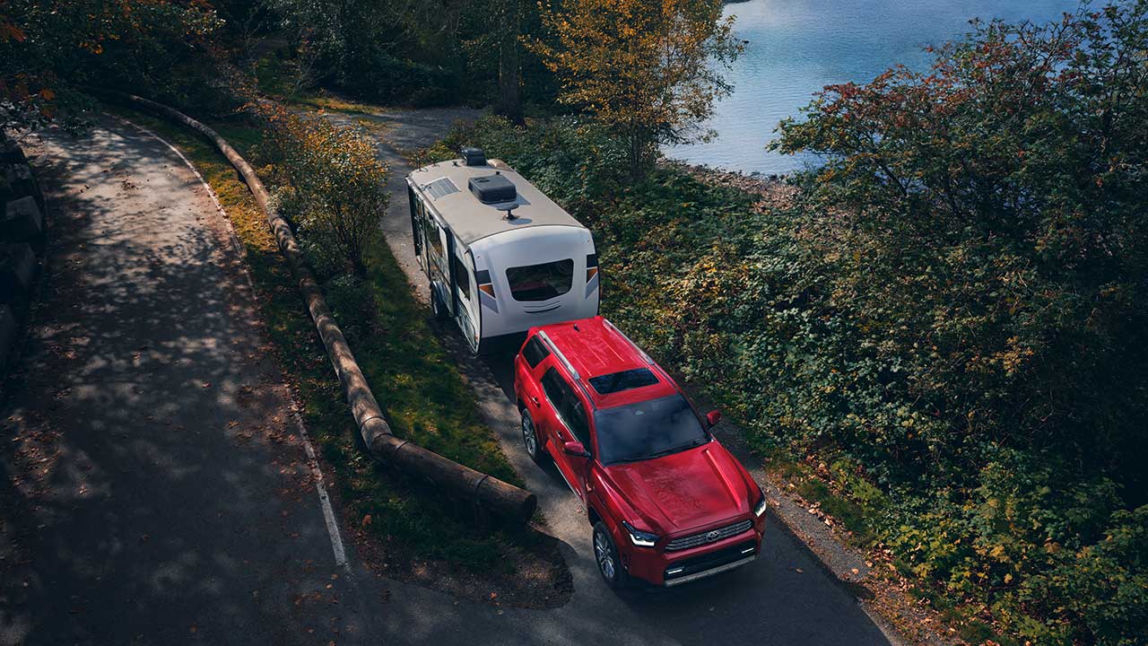 Aerial view of a red  2025 Toyota 4Runner towing a camper