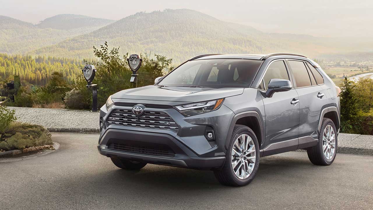 2025 Silver Toyota RAV4 on a street with a mountain in the background