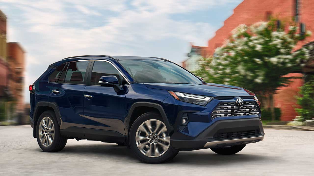 2025 Blue Toyota RAV4 speeding around a corner