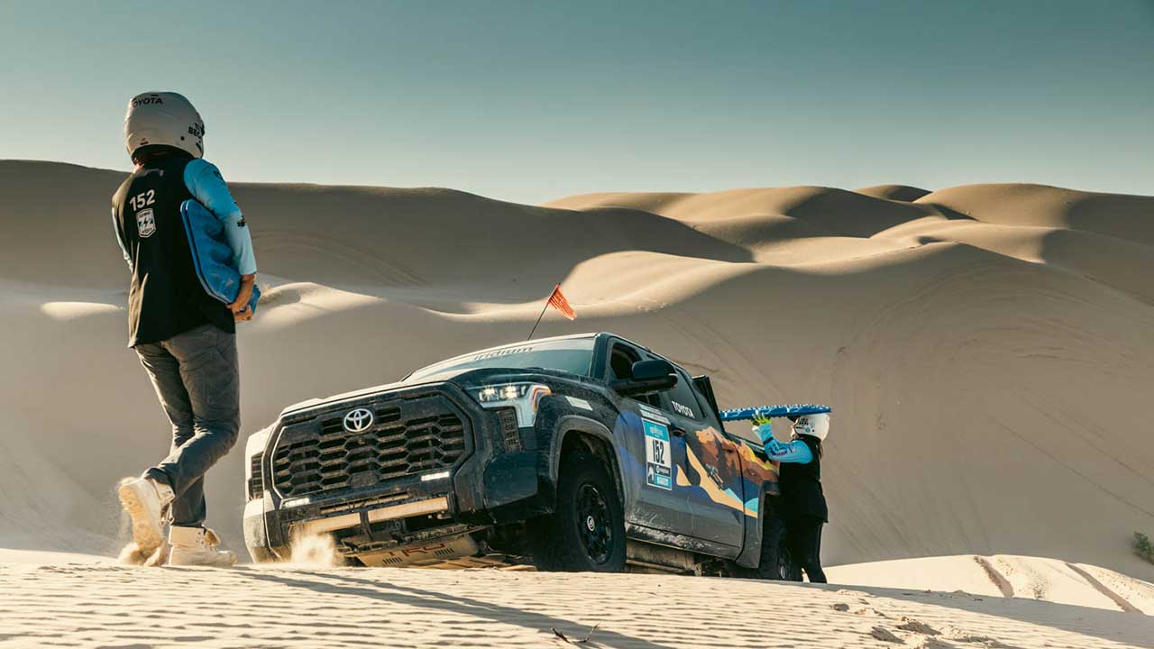 Rebel Rally Toyota vehicle coming up over a ridge towards a driver