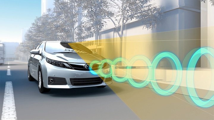 A computer-generated Toyota drives on the road, while a sensor on the top of its windshield scans the pavement in front of the vehicle.