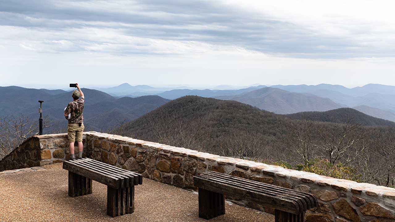 A man looking out into the mountains at Brasstown Bald's Observatory