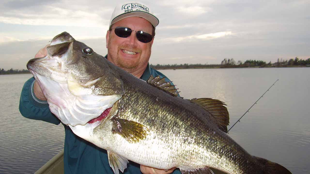 Trophy catch program man with bass