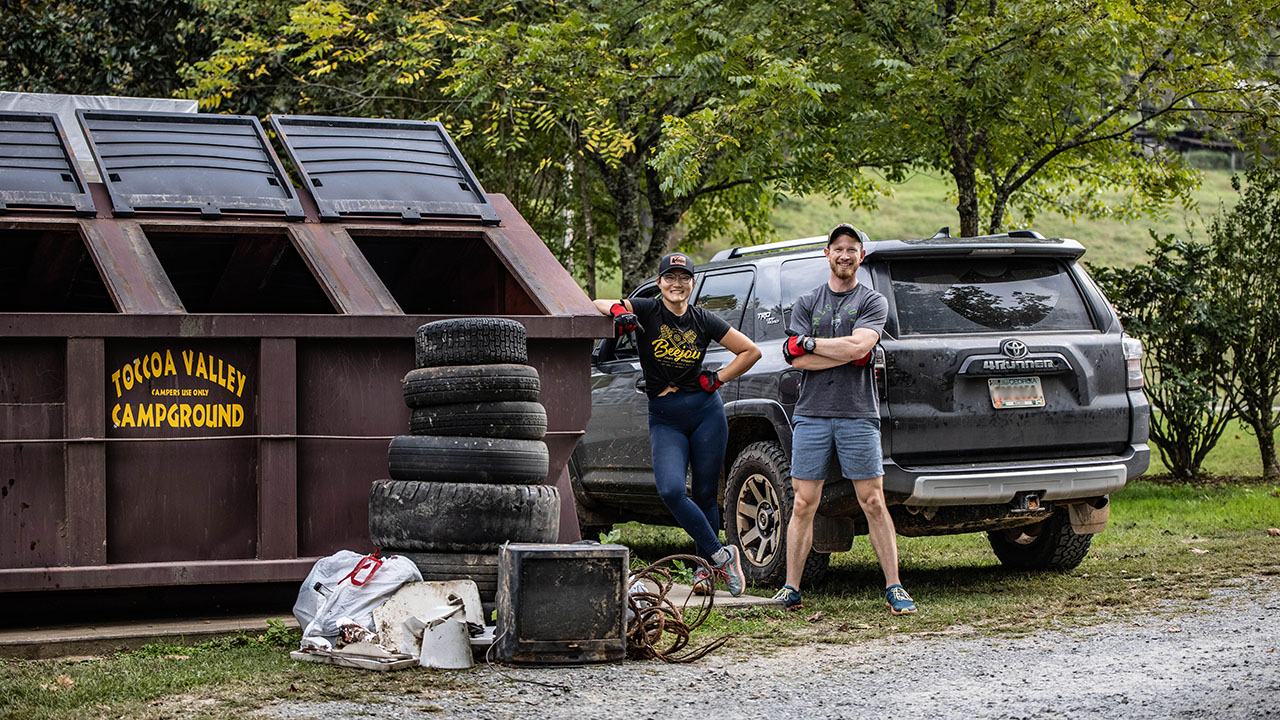 Couple next to a dumpster