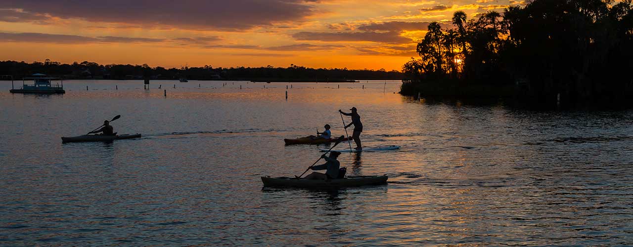 Hero image for Florida's Nature Coast Article Kayakers at Sunset 1280 by 500