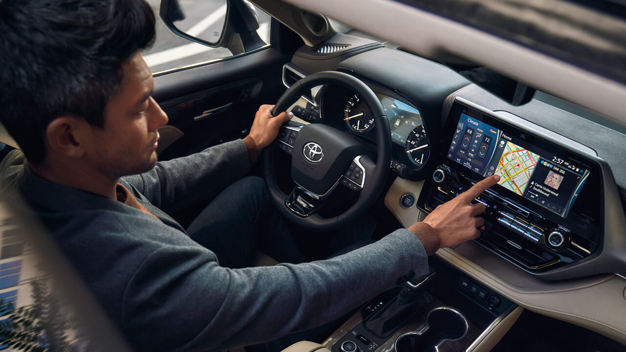 Man adjusting Toyota Highlander dash