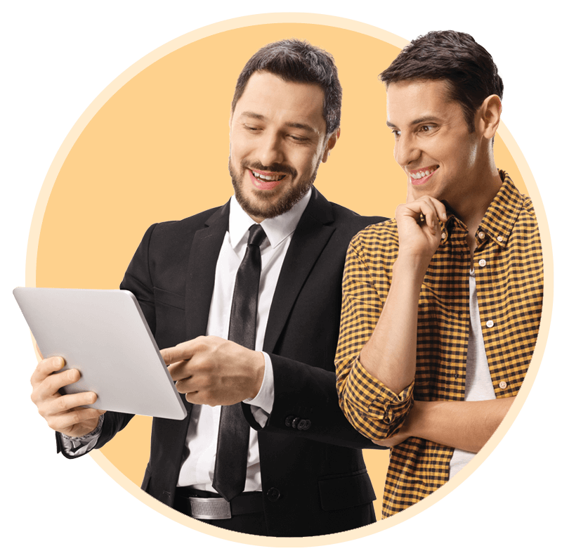 Man in a suit looking showing customer something on a tablet