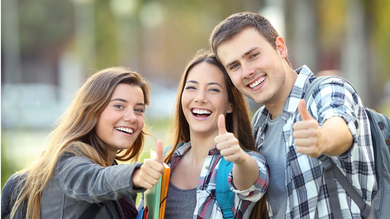 young adults giving thumbs up