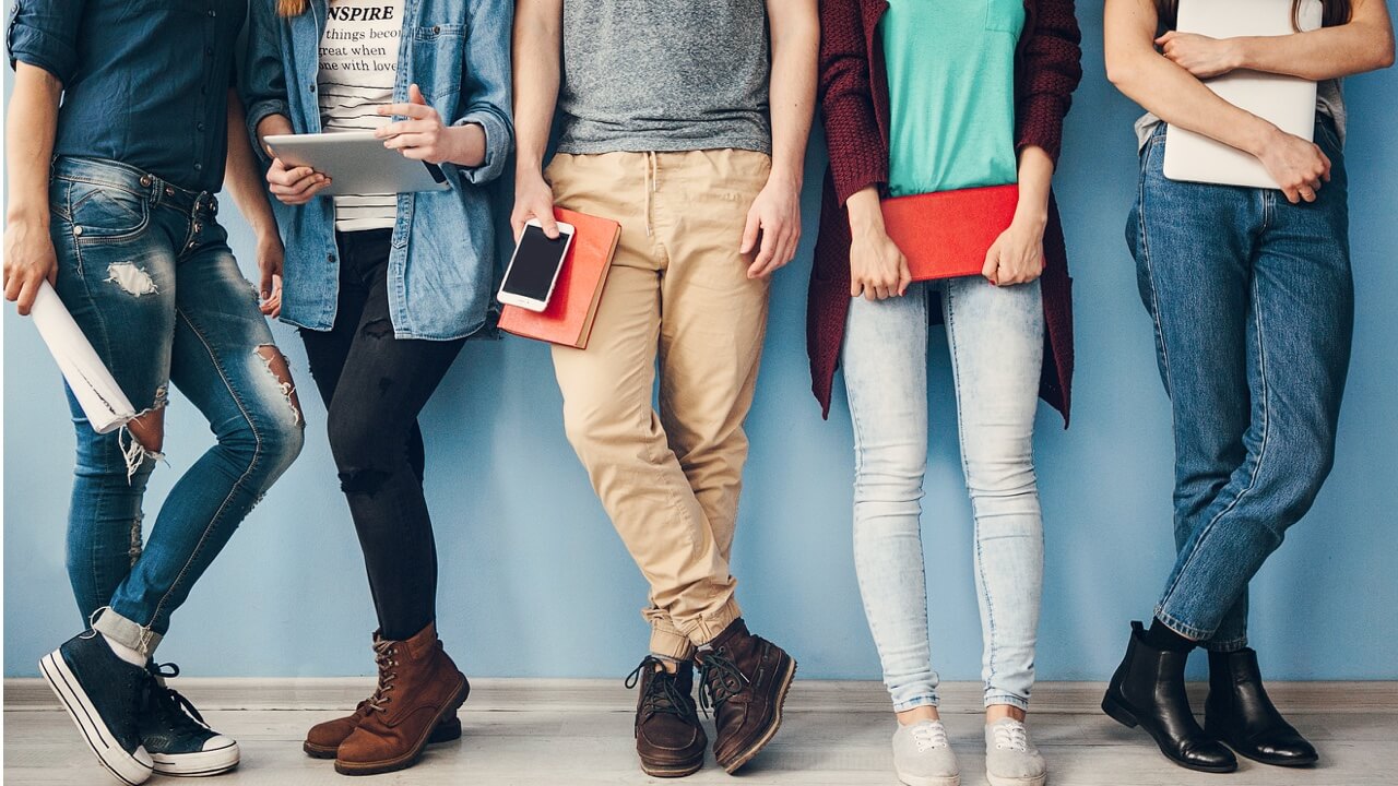 students lined up with books showing only legs