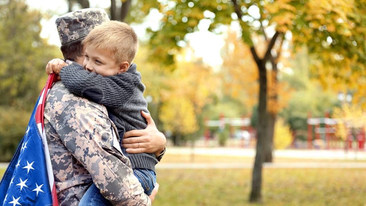 Soldier hugging son