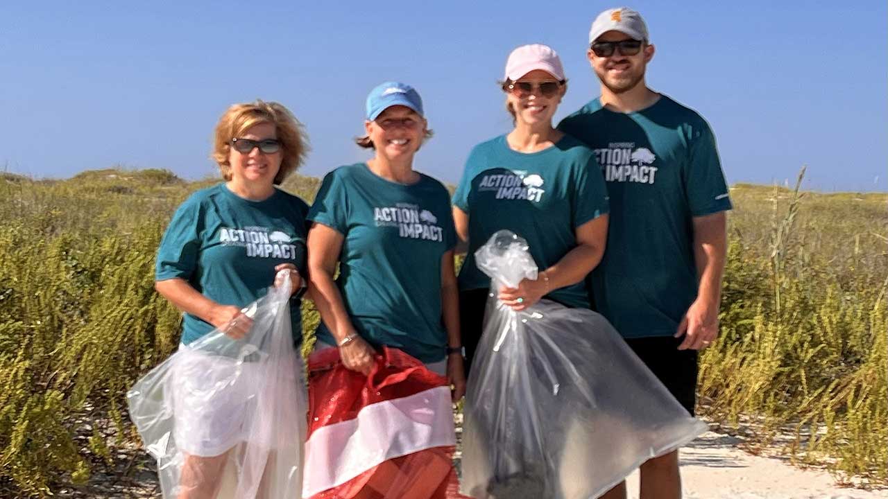 Associates picking up trash on the Mobile coast line