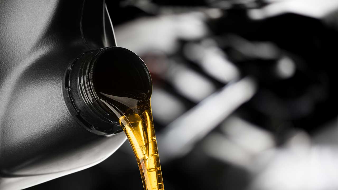 motor oil being poured into engine block