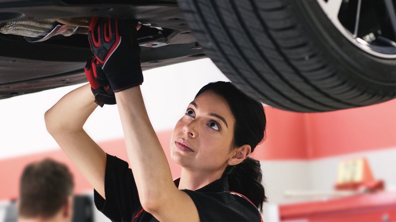 Toyota technician working under car